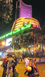 People walk in front of the BSE building during the auspicious Muhurat trading on Laxmi Poojan in Mumbai on Thursday. PTI 