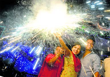 A family celebrates Diwali at Sector 38 West, Chandigarh, on Thursday. 