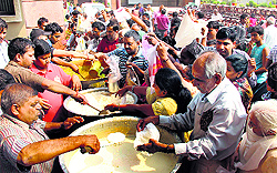 People distribute langar on the occasion of Annkoot festival in Gurgaon on Friday