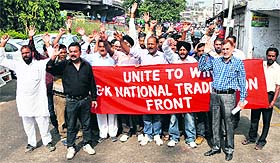 Members of the Jammu and Kashmir Trade Union Front hold a rally in Jammu on Friday. 