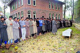 Villagers attend the funeral of police constable Rafiq Ahmad Mir at Hassanpora Bagh in Anantnag district on Friday. 