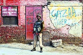 A paramilitary personnel stands guard at a street during a one-day strike called by separatists in Srinagar on Thursday.