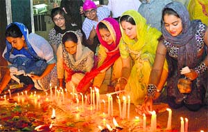 Devotees light candles outside a gurdwara on the occasion of Diwali at Model Town in Jalandhar