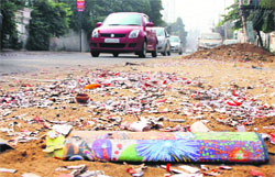 Roads littered with cracker waste after Diwali night on Friday. Tribune Photo: Himanshu Mahajan