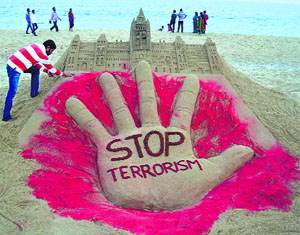 Sand artist Sudarsan Pattnaik creates a sand sculpture with a message Stop Terrorism after the attack on Canadas Parliament, at Puri beach on Friday.