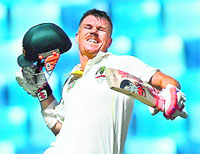 David Warner celebrates after scoring a century. AFP