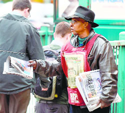A man hands out newspapers near the apartment building of Doctor Craig Spencer in New York on Friday. Spencer, a member of Doctors Without Borders, tested positive for Ebola, making him the citys first Ebola patient. 