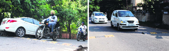 A motorcyclist crosses a speed-breaker on a road; and (right) vehicles pass through the missing portion of a speed-breaker on a road at Basant Avenue in Amritsar on Saturday. Photo: R.K. Soni
