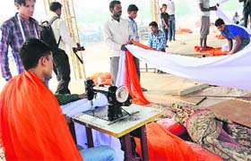Tents being prepared in hues of saffron and white at the venue