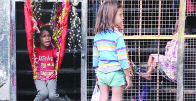 Streetchildren find their own way of enjoying themselves in North Delhi on Saturday.