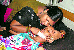 an injured child being consoled by her mother at a hospital in Jalandhar