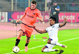 Chennaiyins Dhanachachandra Singh tries to tackle Delhi Dynamos Mads Junker during their ISL match in New Delhi on Saturday. 