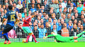 West Ham Uniteds Morgan Amalfitano scores the opening goal against Manchester City during the EPL match in London on Saturday.