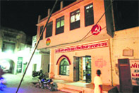 the exterior of the community library, with the village gate in the backdrop 