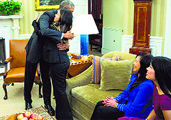 President Barack Obama hugs Ebola survivor Nina Pham in the Oval Office of the White House in Washington