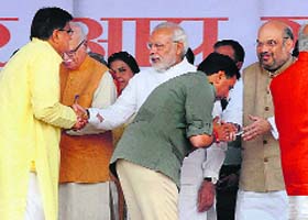 BJP Badli MLA Om Prakash Dhankar (in yellow) and Narnaund MLA Capt Abhimanyu greet PM Narendra Modi and party chief Amit Shah after being sworn in on Sunday