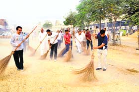 Grain market traders clean their market in Sirsa on Sunday