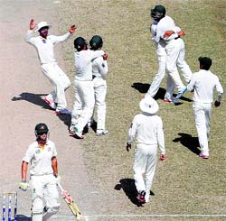 Pakistan celebrate after dismissing Mitchell Marsh on the fifth day of the first Test in Dubai on Sunday.