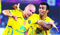 Keralas Iain Hume celebrates with Milagres Gonsalver after scoring a goal during their ISL match in Kolkata on Sunday