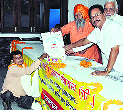 Members of the Parvatiya Viklang Sewa Sansthan falicitate a handicaped person at a programme in Dehradun on Sunday