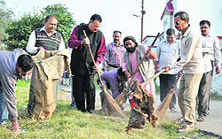 MLA Ganesh Joshi and members of the Bihari Mahasabha undertake a cleanliness drive at the Tapkeshwar temple in Dehradun on Sunday