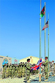 British soldiers lower the Union Jack during a handover ceremony before their military withdrawal from the Camp Bastion-Leatherneck complex at Lashkar Gah on Sunday. 