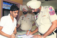 Police officers perform security checks at a hotel near the railway station ahead of the Union Ministers visit in Bathinda. Tribune photo
