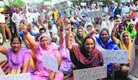 Villagers protest in front of Municipal Bhawan, Sector 68, Mohali, on Monday.