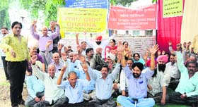 Members of the Government of India Textbooks Press Workers Union hold a protest in Chandigarh on Monday.