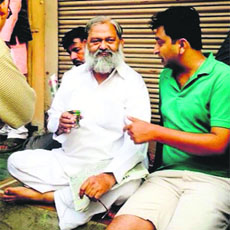 Anil Vij talks to a supporter over tea in Sadar Bazaar area of Ambala Cantt on Monday morning.