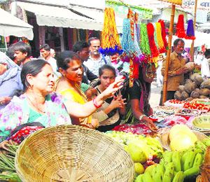 Women shop on Nahai-Khai that marks the beginning of the four-day Chhath Puja, in Gurgaon on Monday.