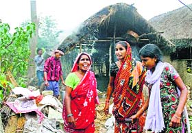 Women wailing after their houses were set ablaze during a clash between TMC and BJP workers at Makra village in Birbhum on Monday