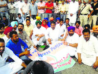 Youth Congress workers on a dharna outside the DRMs office in Ferozepur on Monday. Tribune photo