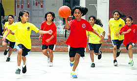 Players in action in a match between Shigally Hills School (in red) and Aryan School (in yellow) in the Tek Chand Memorial Sub-junior Inter-school Girls Basketball Tournament in Dehradun on Monday. 