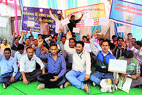 Unemployed diploma pharmacists hold a protest to demand government jobs in Dehradun on Monday.