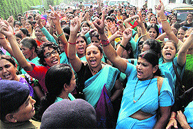 Anganwadi workers protest in support of their demands in Dehradun on Monday