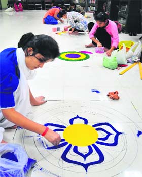 Girls make rangoli during the youth festival at DAV College in Sector 10, Chandigarh, on Tuesday