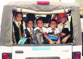 An overloaded TATA Magic plies on a road in Dera Bassi on Tuesday
