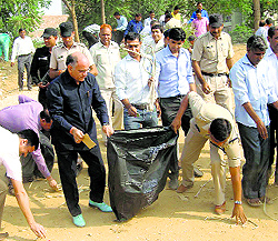 Administrative officials collect rubbish during a cleanliness drive in Rewari