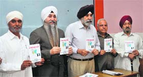Dignitaries release a book, JKMMPC Front, in Jammu on Tuesday.