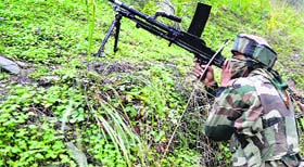 A soldier takes a position during an encounter with militants at Handwara in Kupwara on Tuesday.