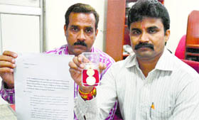 Activists show coins with the engraving of Goddesses and a copy of the complaint