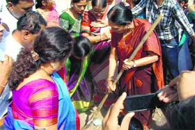 Gujarat CM Aanandiben Patel sweeps a road as part of Swachh Bharat Abhiyan in Surat on Tuesday.