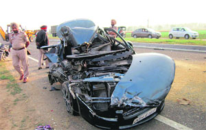Mangled remains of a car that collided with a stationary truck on the Batala road bypass in Amritsar on Wednesday.