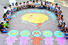 Students of the Center for Social Work pose with a pictorial awareness message on World Stroke Day at Panjab University in Chandigarh on Wednesday.