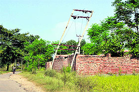 An electricity pole leans dangerously on the outskirts of Jammu. 