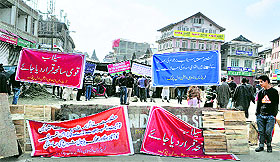 Traders sit on a hunger strike at Lal Chowk in Srinagar on Wednesday. They have been demanding rehabilitation and international aid for the Valley. 