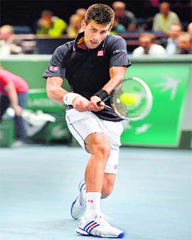 Novak Djokovic returns to Philipp Kohlschreiber during their second-round match of the Paris Masters on Tuesday night