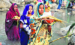 Women perform rituals to Sun god as part of Nirjala Vrata on the Chatth festival on the Ganga ghat in Haridwar on Wednesday
