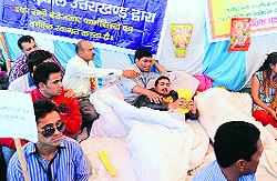Unemployed diploma pharmacists protest in support of their demands in Dehradun on Wednesday